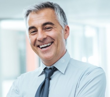 Man with flawless smile after porcelain veneer